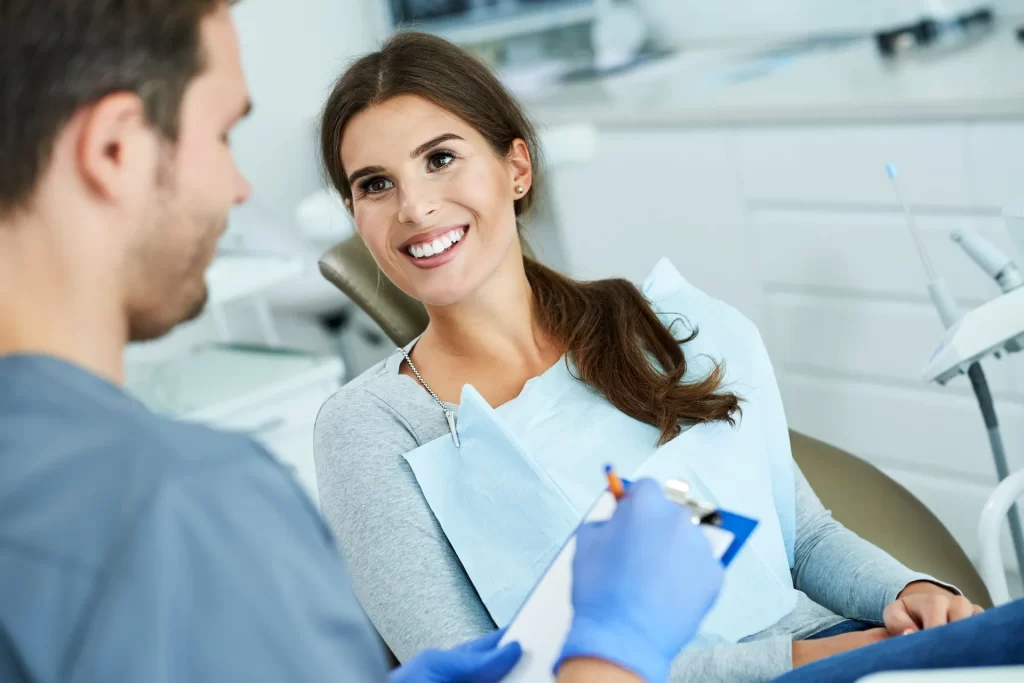 Male dentist and woman in dentist office