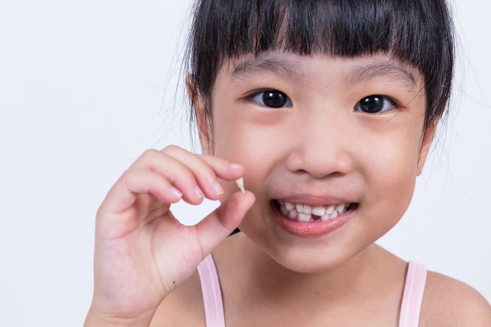 When can my child return to school after a tooth extraction?